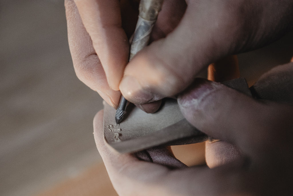 Luis Torres signing his ceramic bow ties Bowtery inspired by the legacy of his potter family.